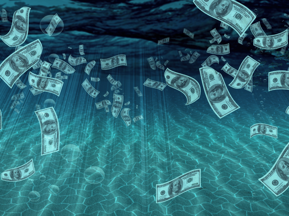 US dollars floating in water representing liquidating a business