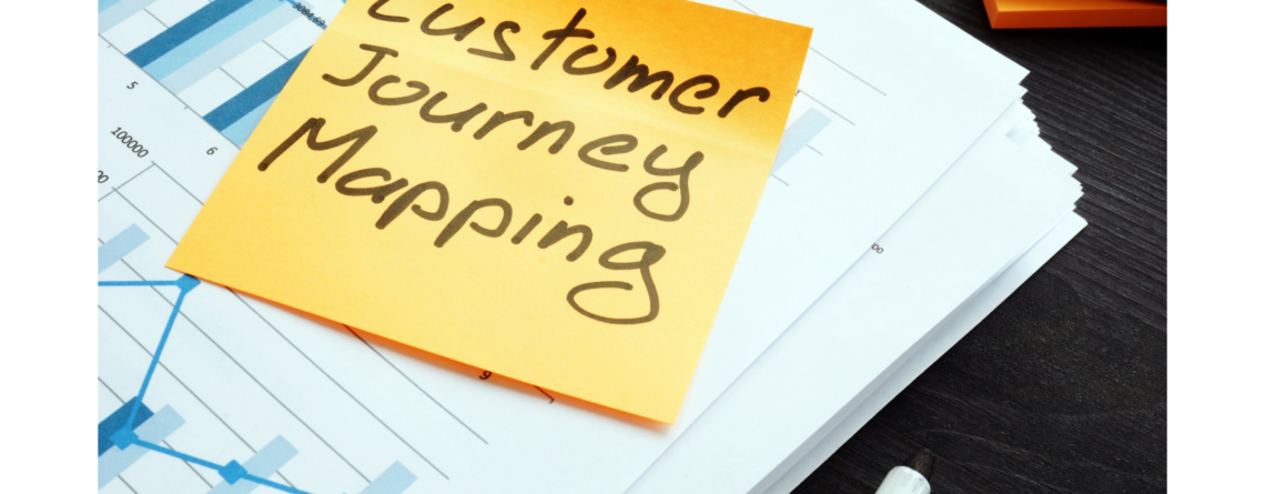 a yellow note on a piece of paper that says "customer journey mapping"