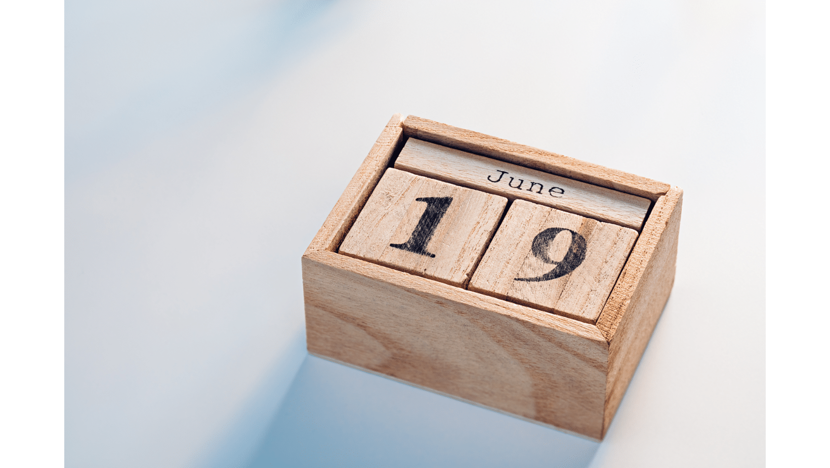 a wooden block calendar with date and month