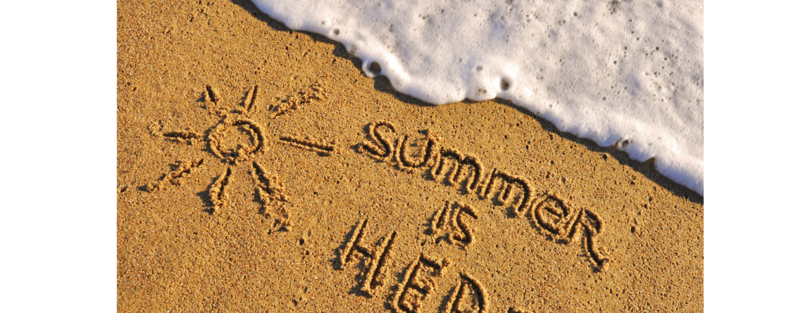 a sun and text written in sand that says "summer is here"