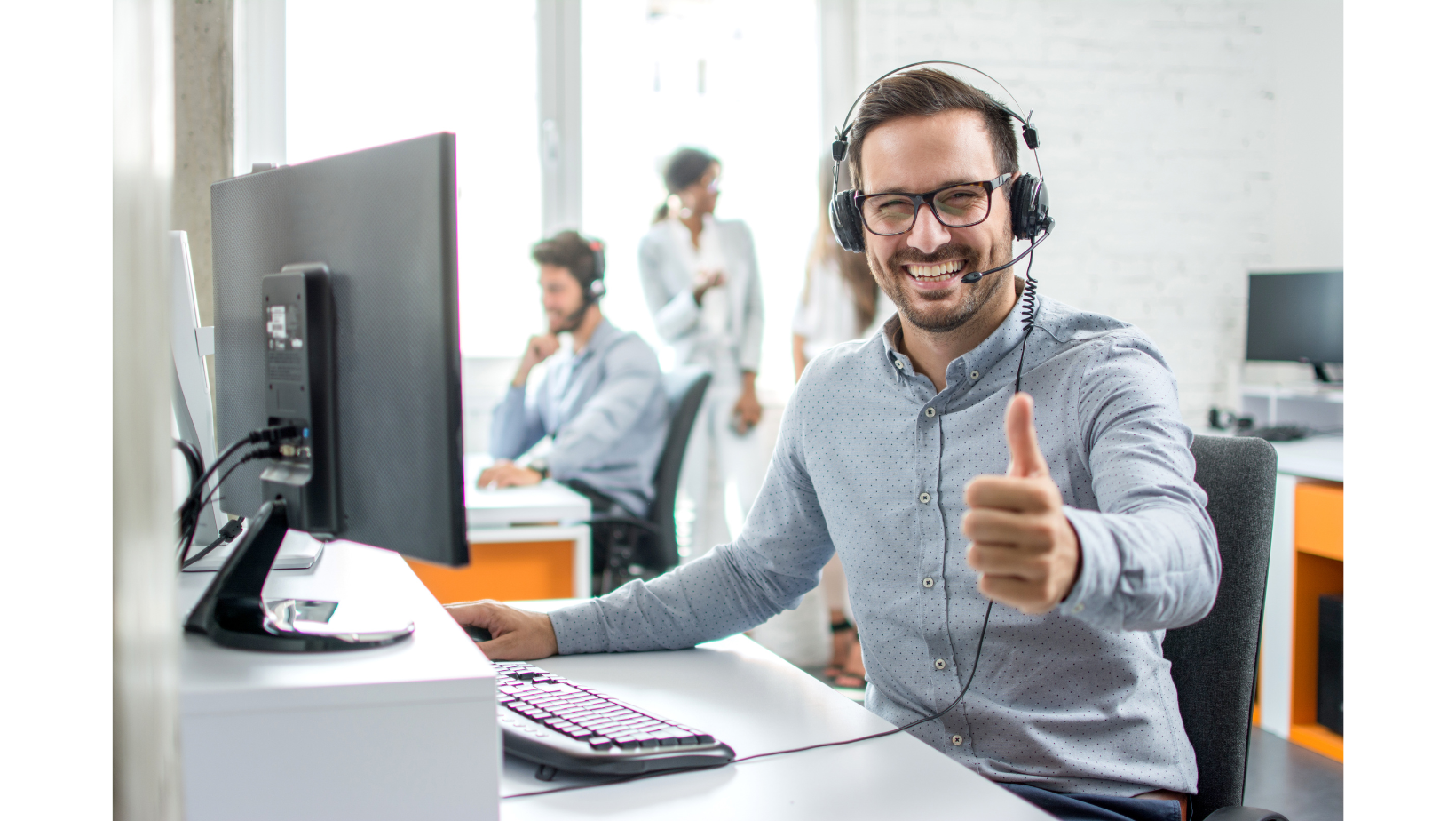 a man wearing headphones and giving a thumbs up